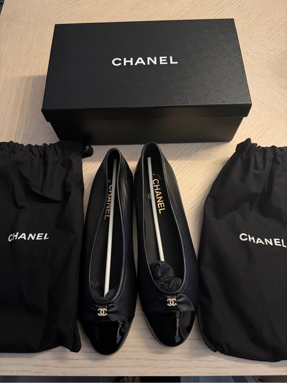 CHANEL Black Leather Cap-Toe Ballet Flats with Patent Toe and CC Charm